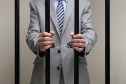 bigstock-Businessman-behind-bars-in-pri-44958667.jpg